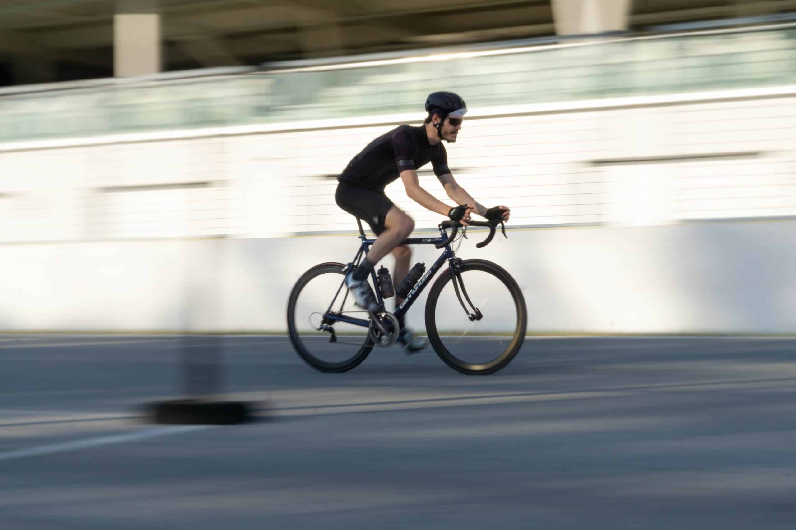 man riding a bike fast in the city