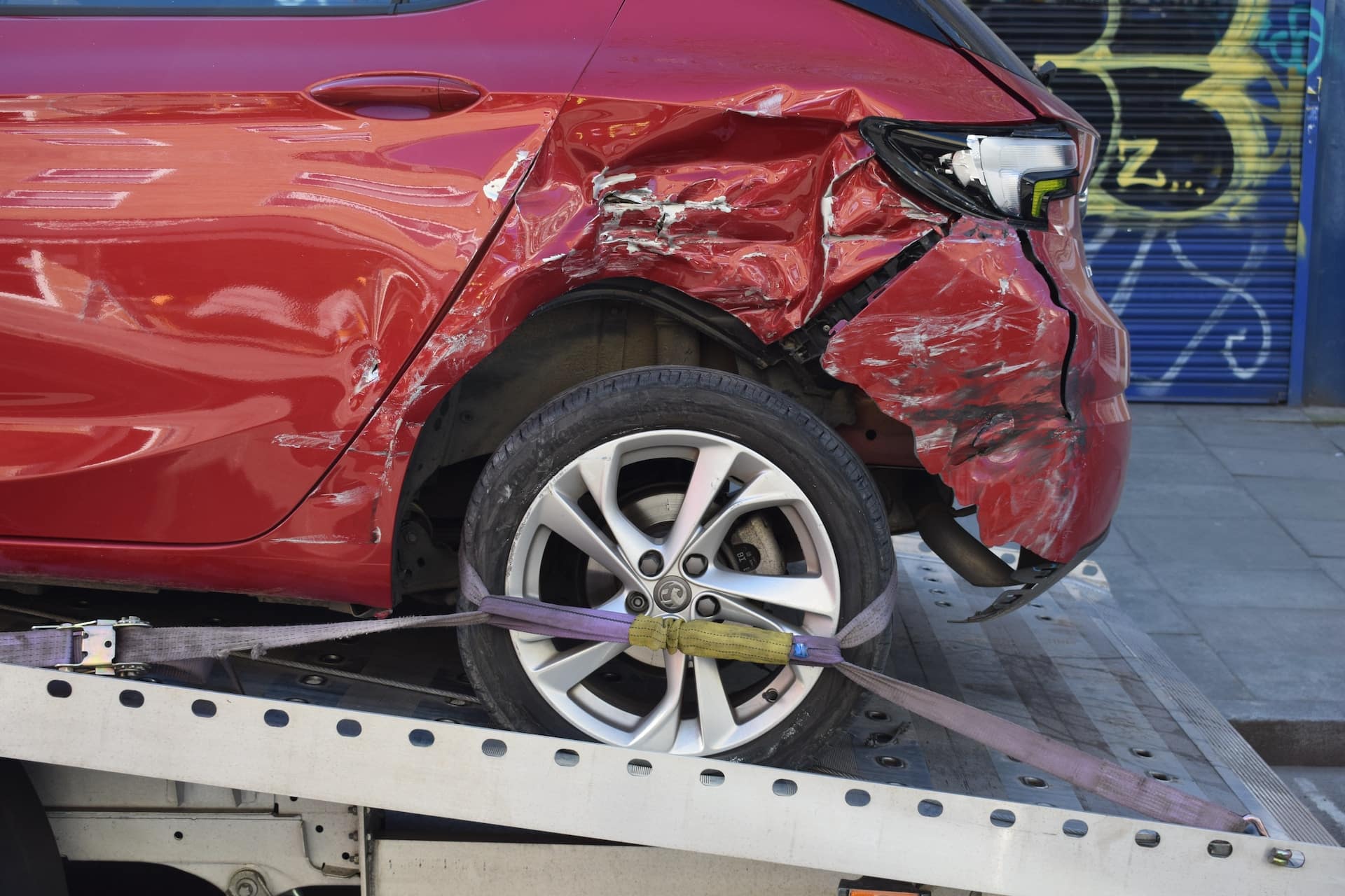 damaged vehicle being loaded onto trailer