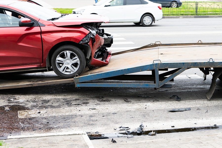 Tow truck for emergency car move. The car after the accident is loaded on a tow truck.